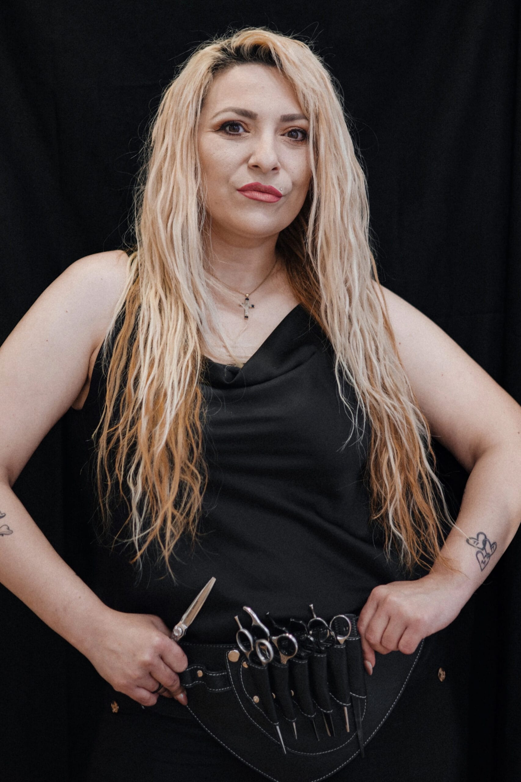 a woman with long blonde hair and a black dress