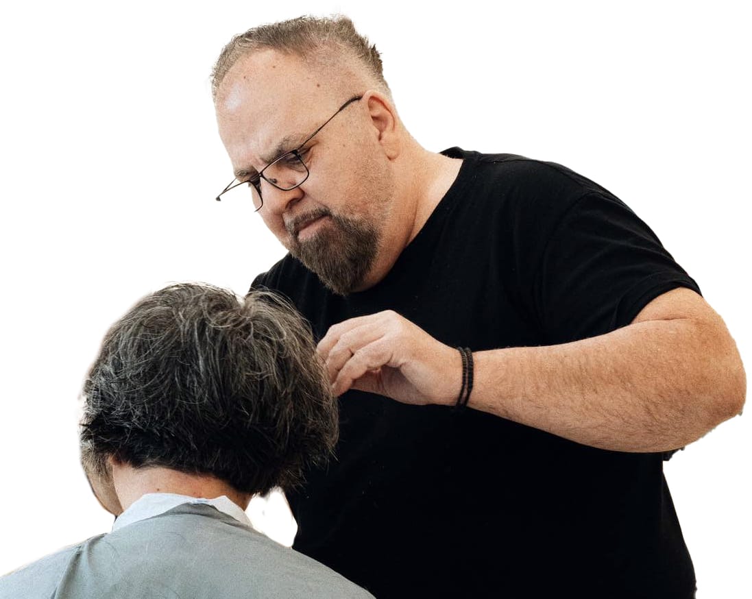 Κομμωτήριο 16 a man combing a person's hair